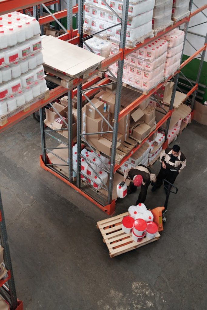 pexels-photo-4481532 Warehouse workers organizing inventory on shelves, enhancing logistics efficiency.